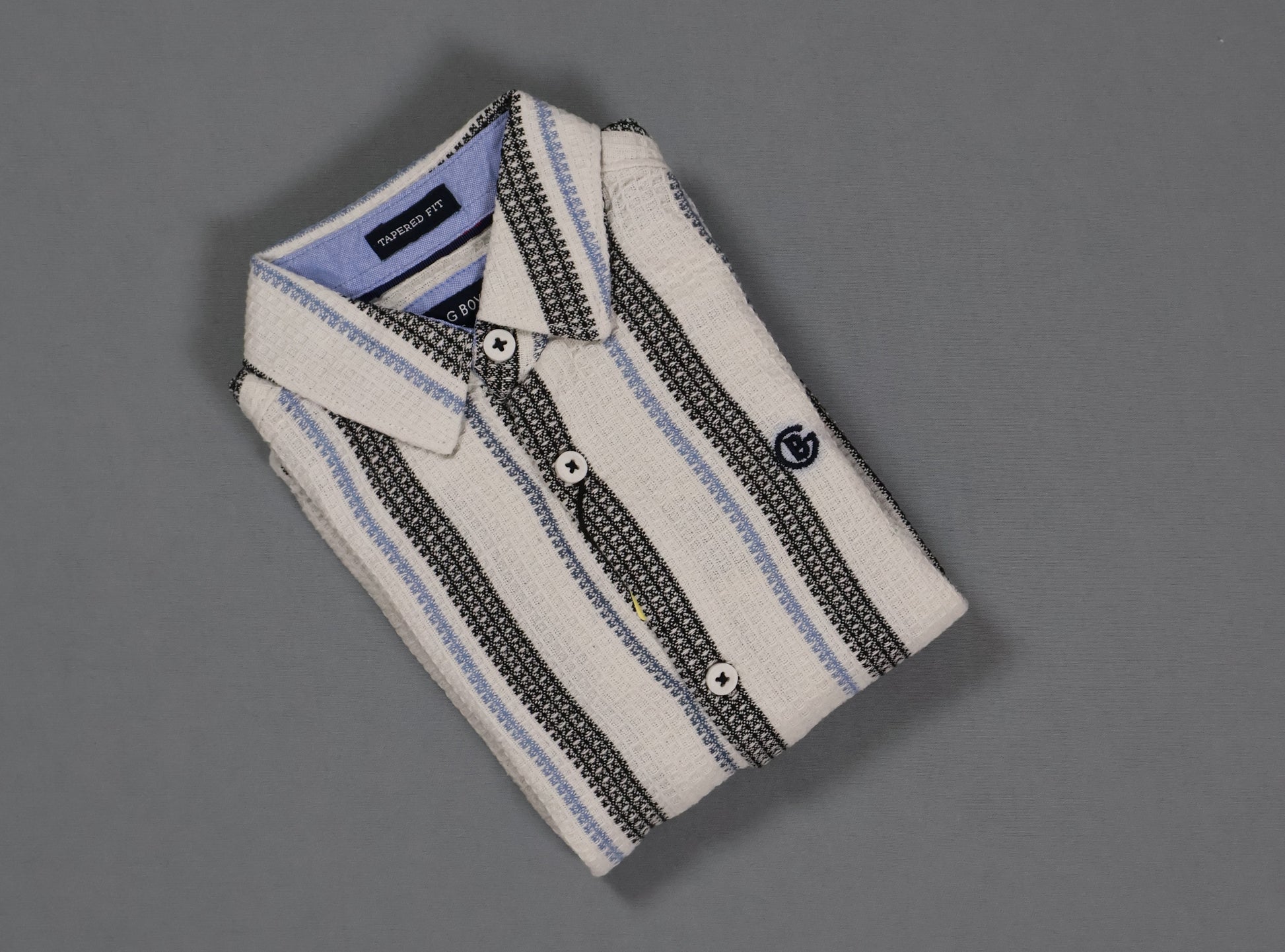 Folded striped shirt on a gray background