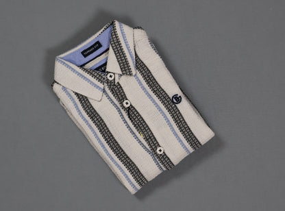 Folded striped shirt on a gray background