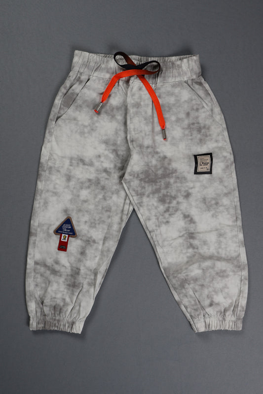 Gray sweatpants with orange drawstring on a gray background