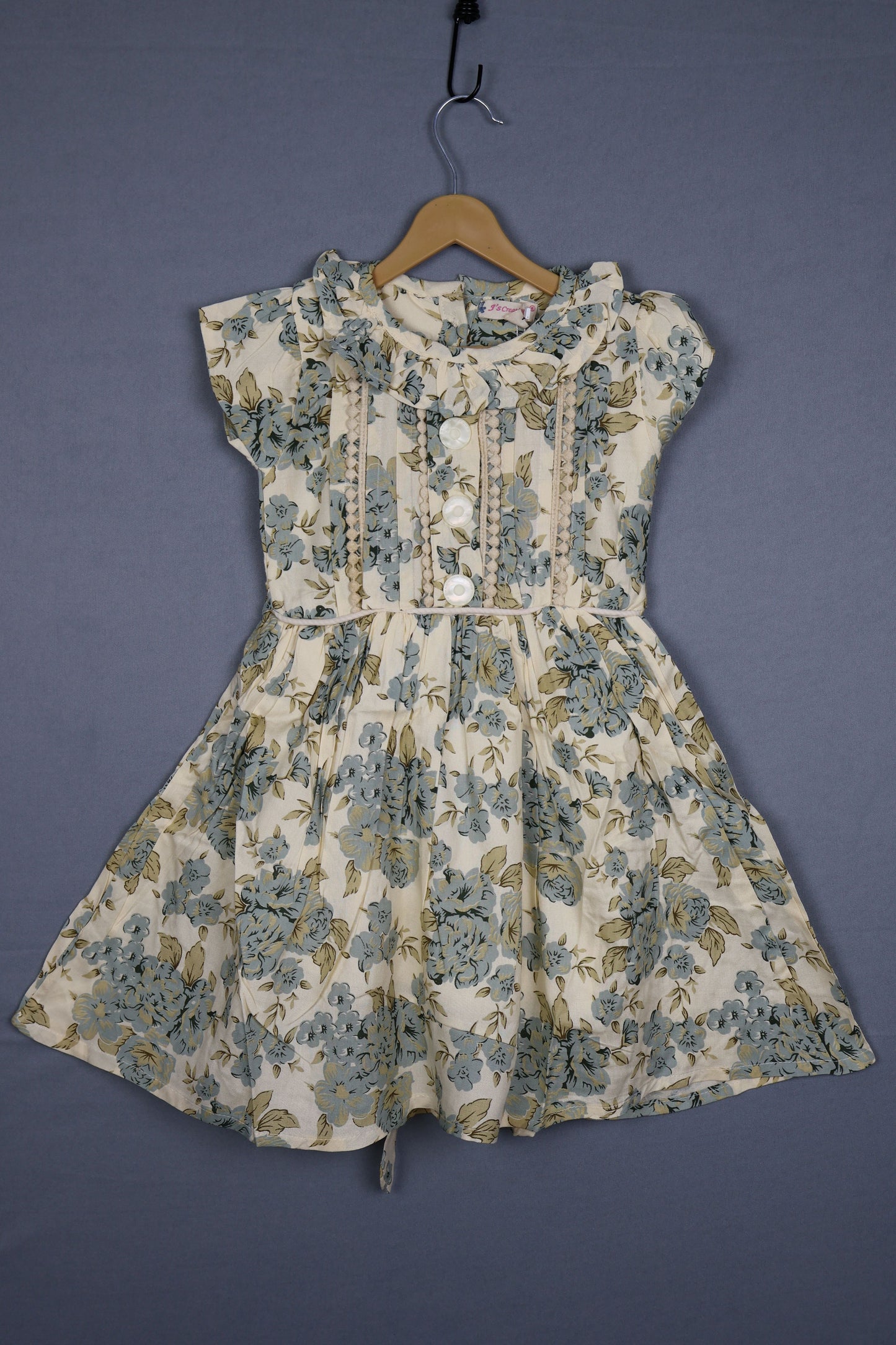 Cream kids cotton dress with blue floral print and ruffled collar, short sleeves, button-front