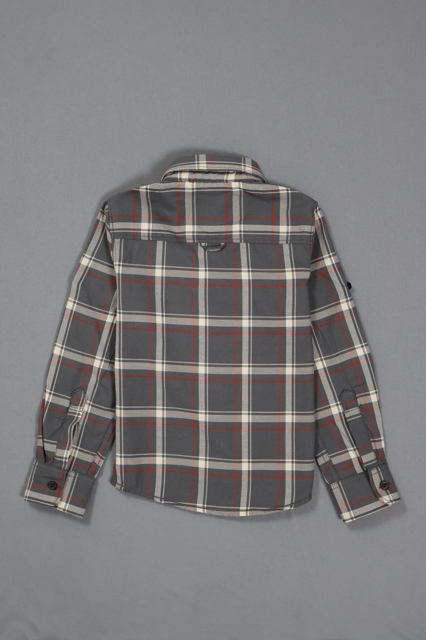 Plaid shirt with gray, red, and white pattern on a gray background