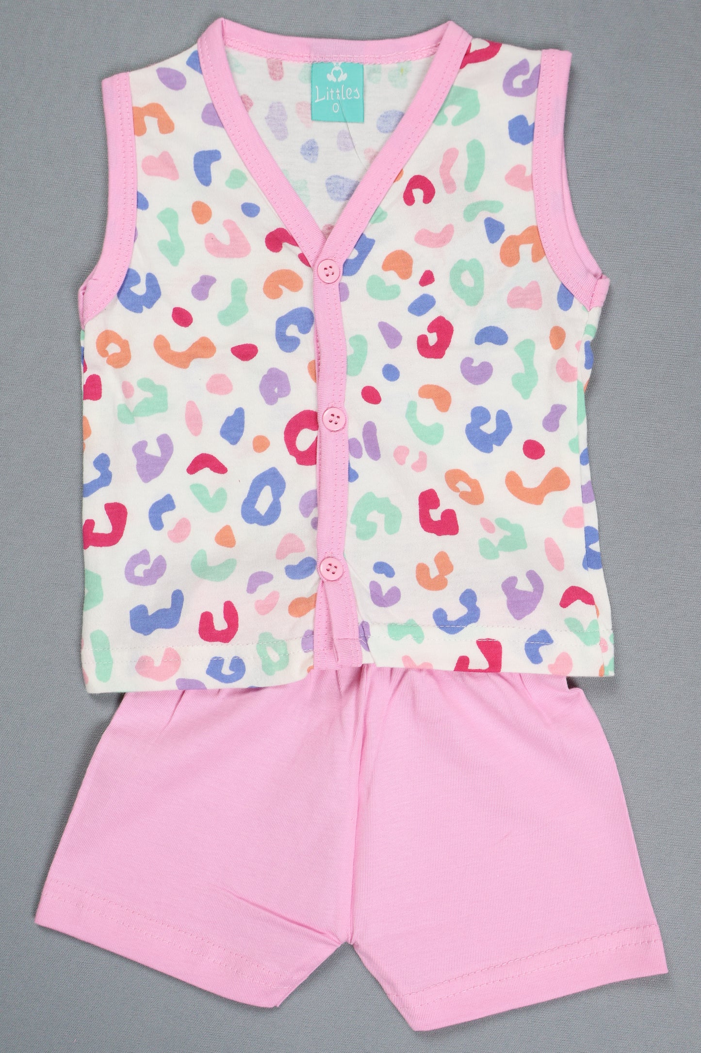 Baby romper with colorful leopard print and pink trim on a gray background