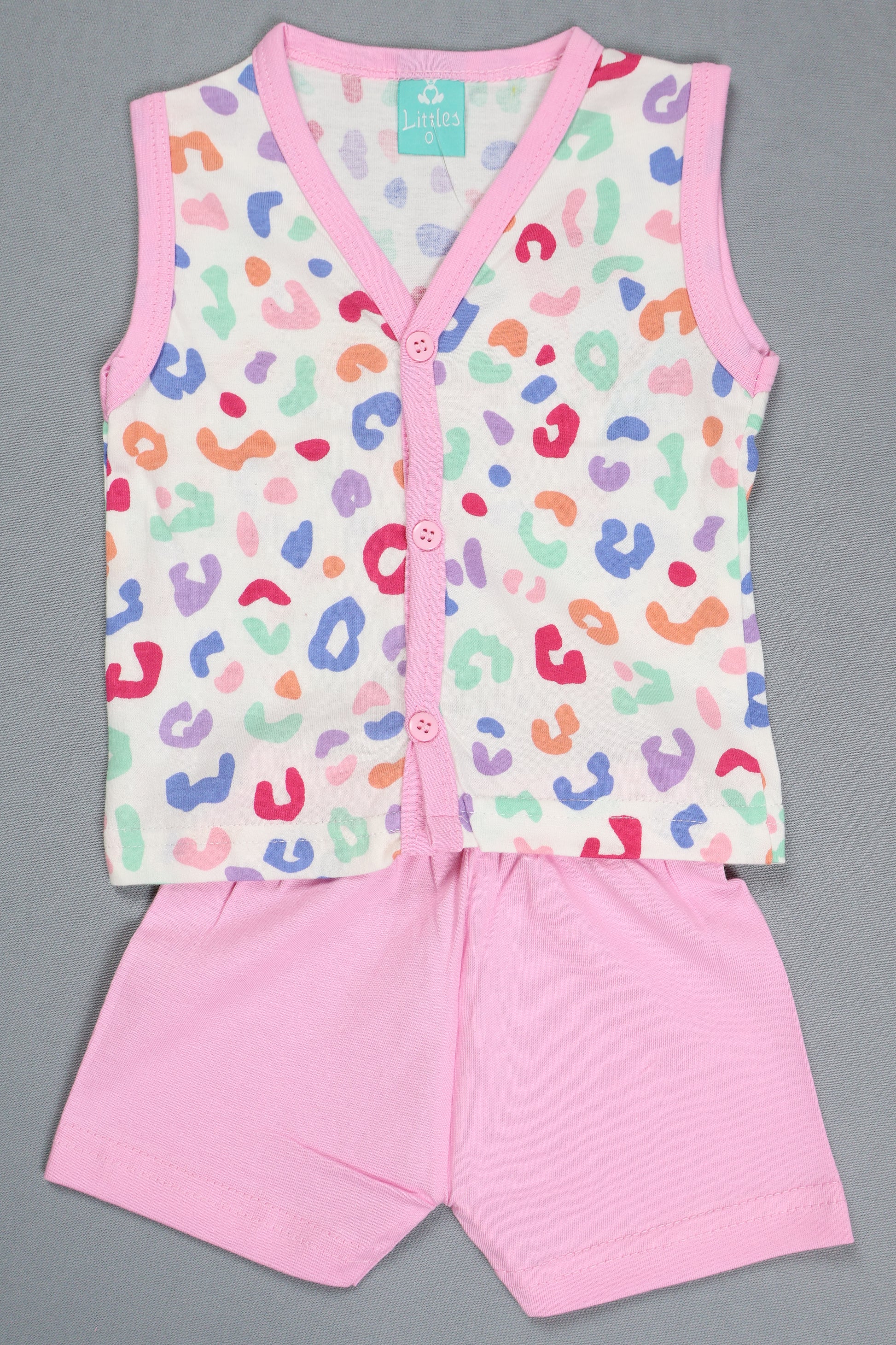 Baby romper with colorful leopard print and pink trim on a gray background