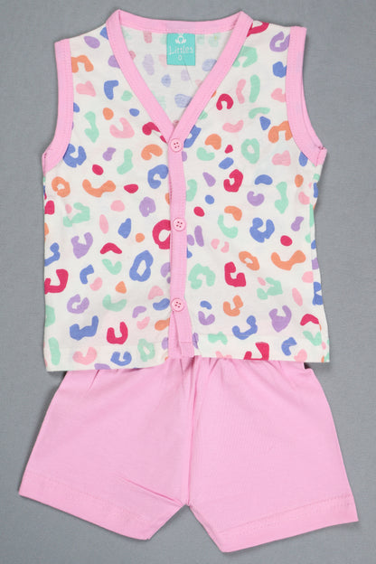 Baby romper with colorful leopard print and pink trim on a gray background