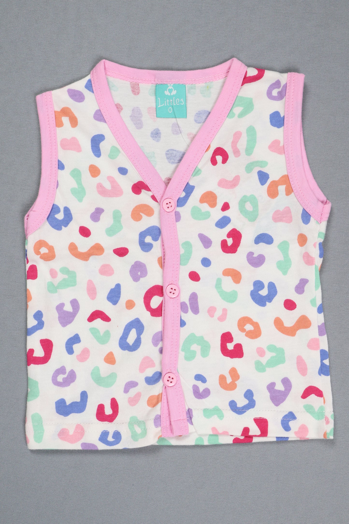 Baby romper with colorful leopard print and pink trim on a gray background