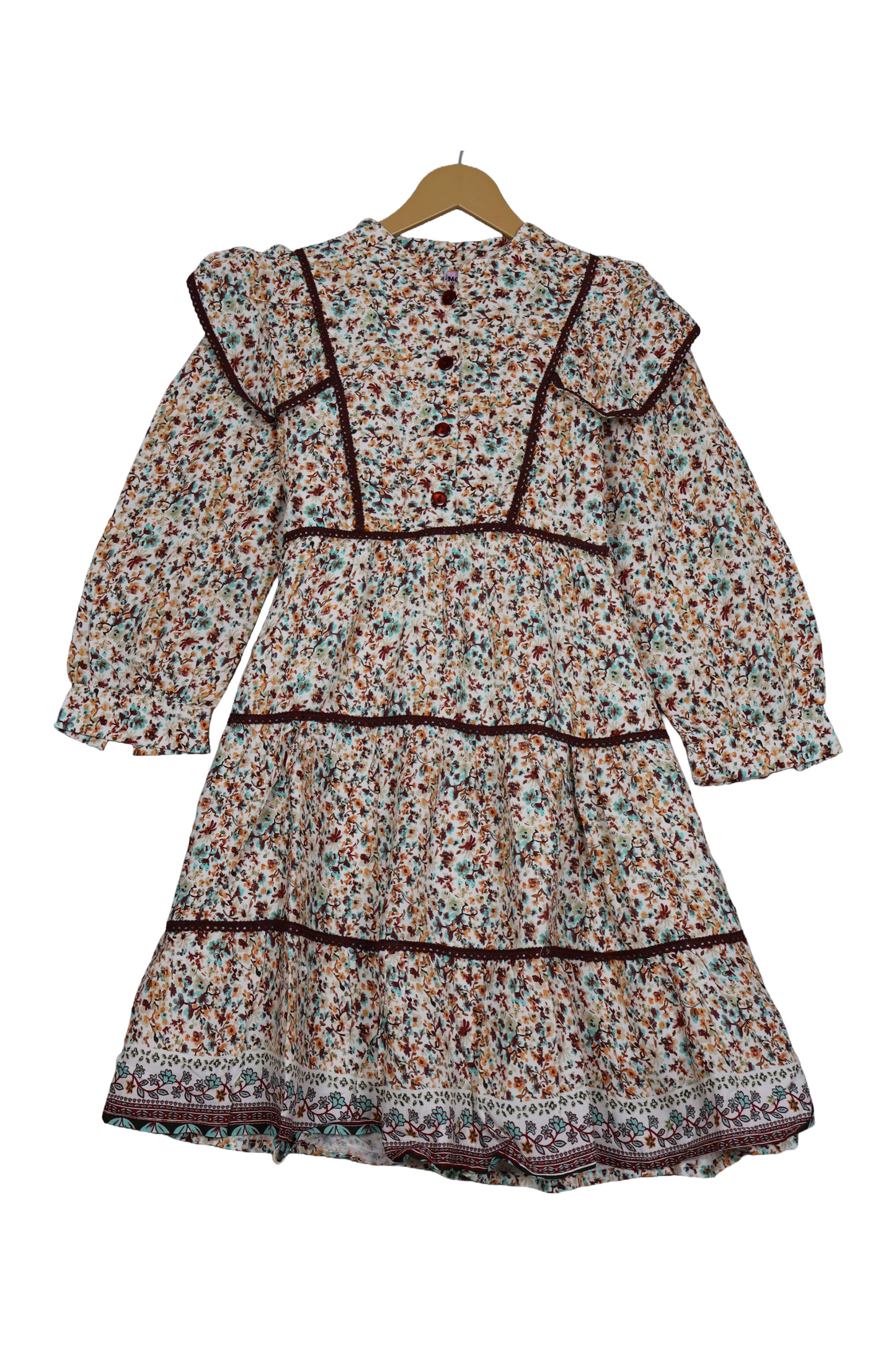 Floral dress on a hanger against a white background