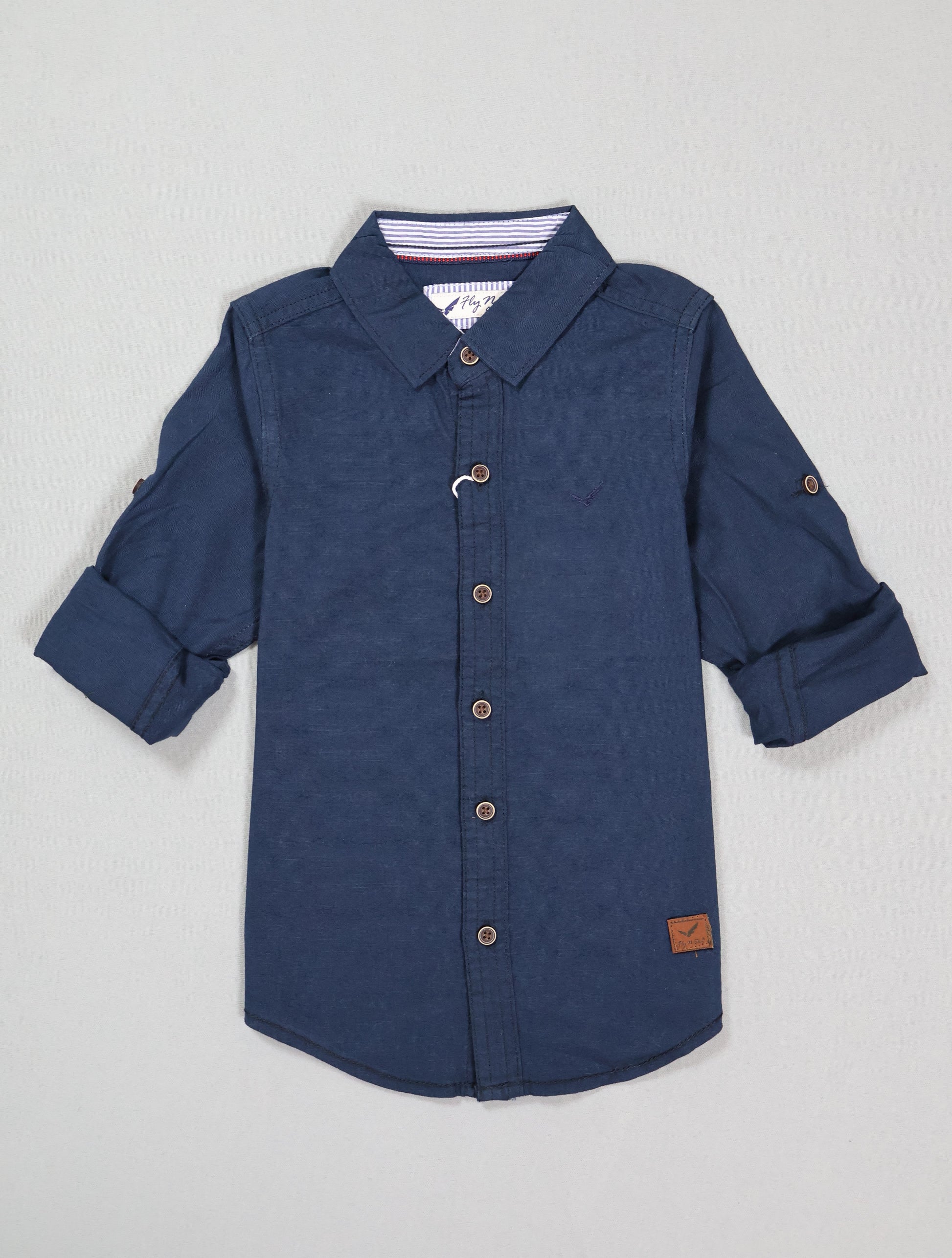 Blue button-up shirt with rolled-up sleeves on a light gray background
