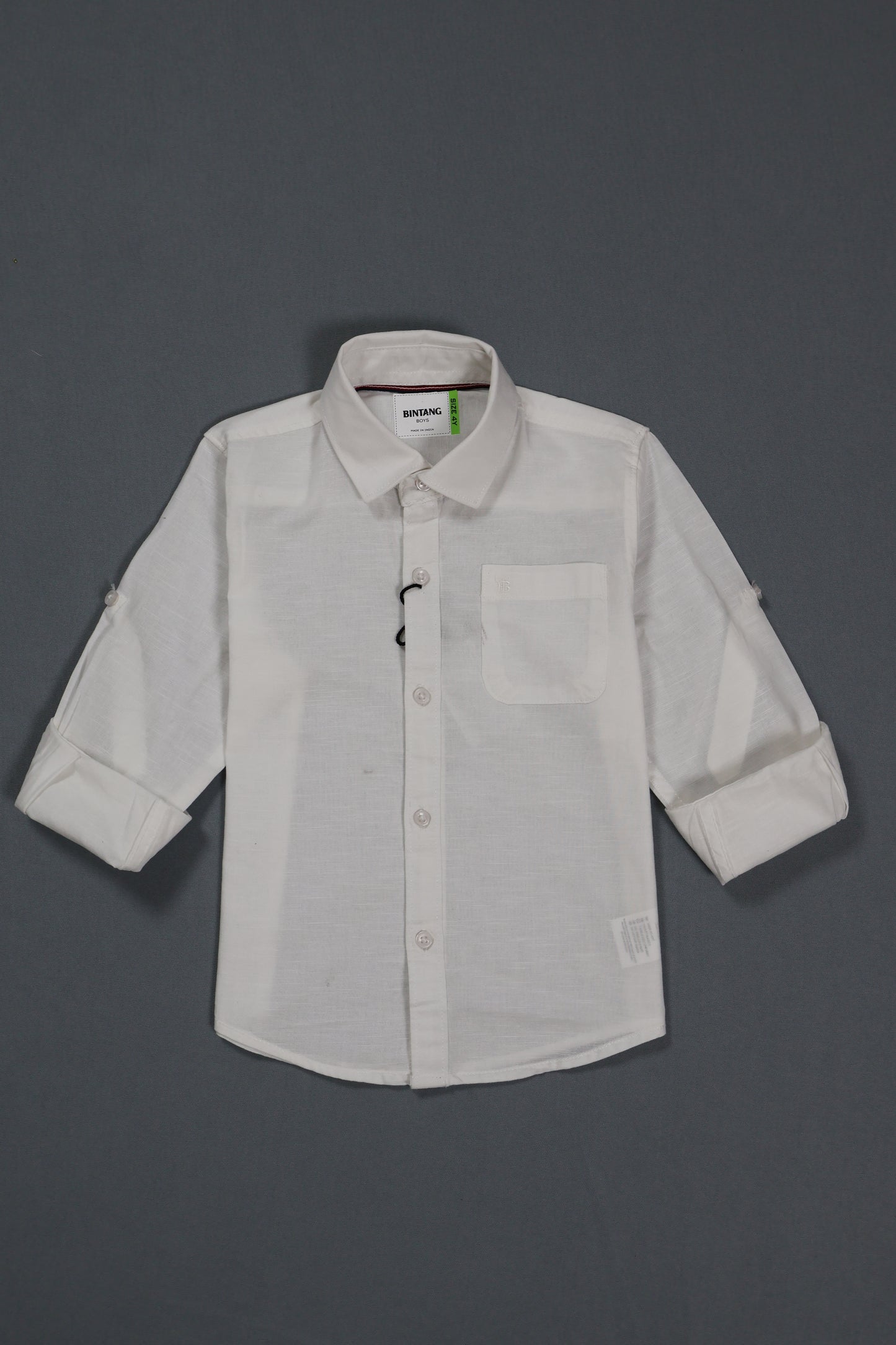 White shirt with rolled-up sleeves on a gray background