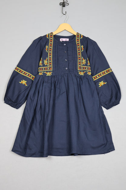 Navy blue shirt with gold embroidery on a gray background