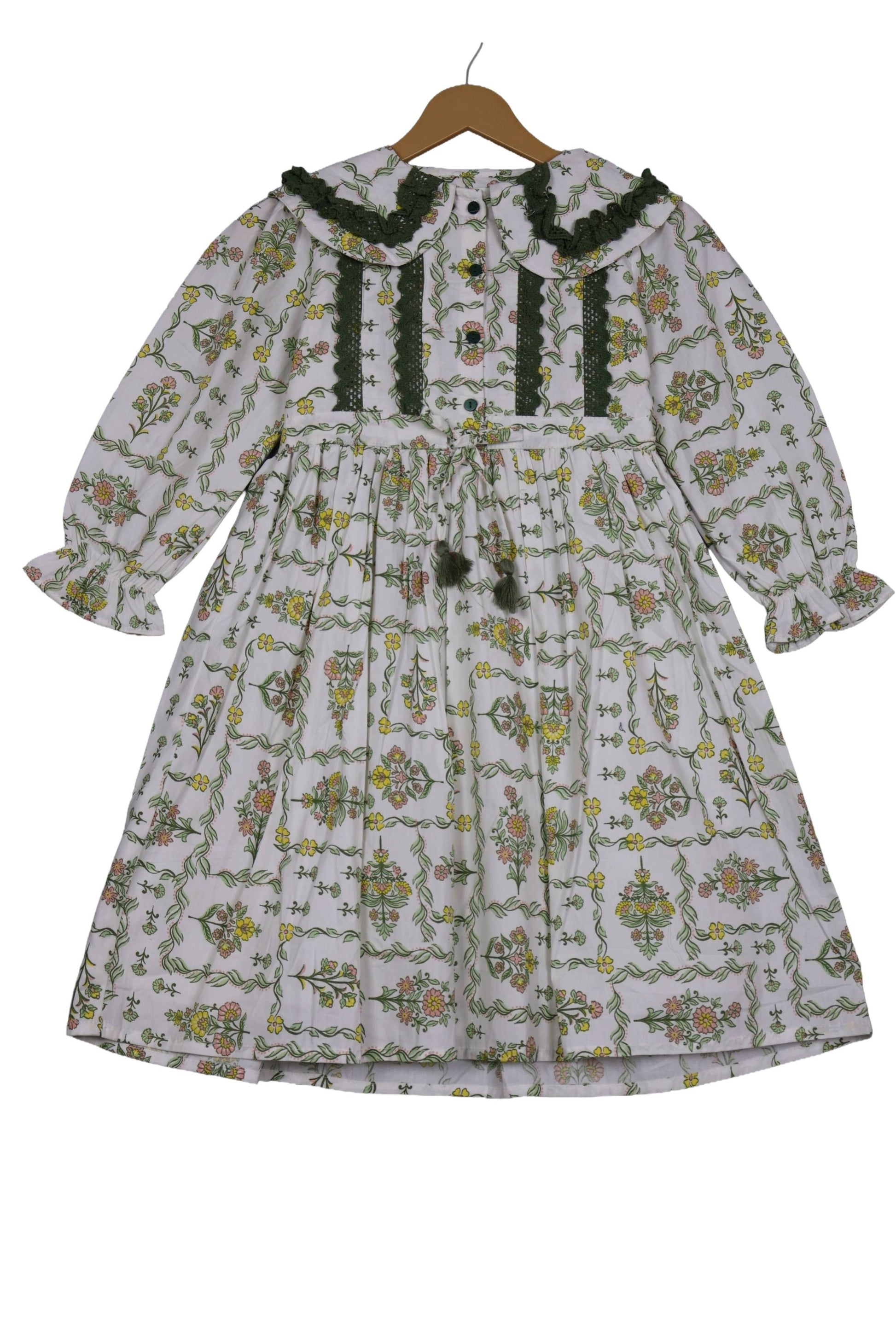 Floral patterned dress on a hanger against a white background