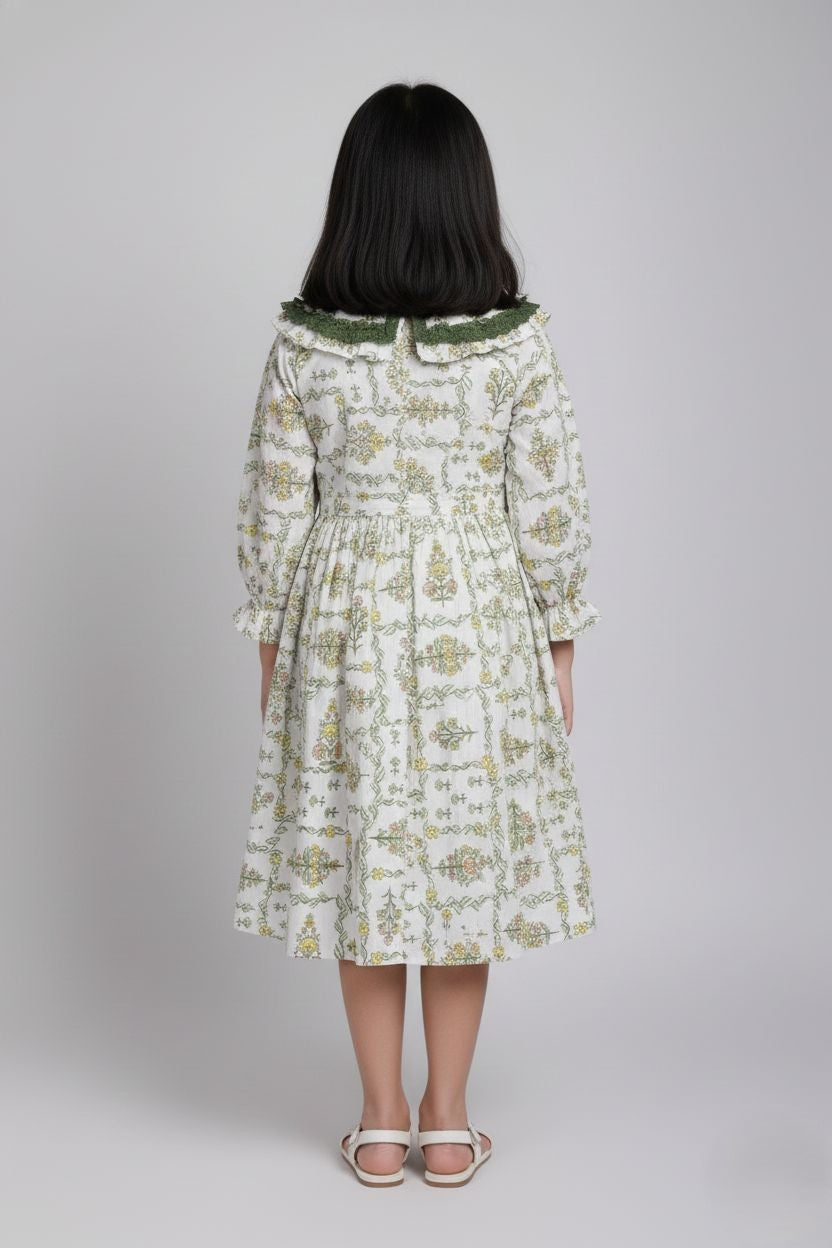 Woman wearing a floral dress with long sleeves on a plain background
