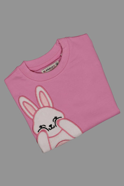 Pink t-shirt with a bunny design on a gray background