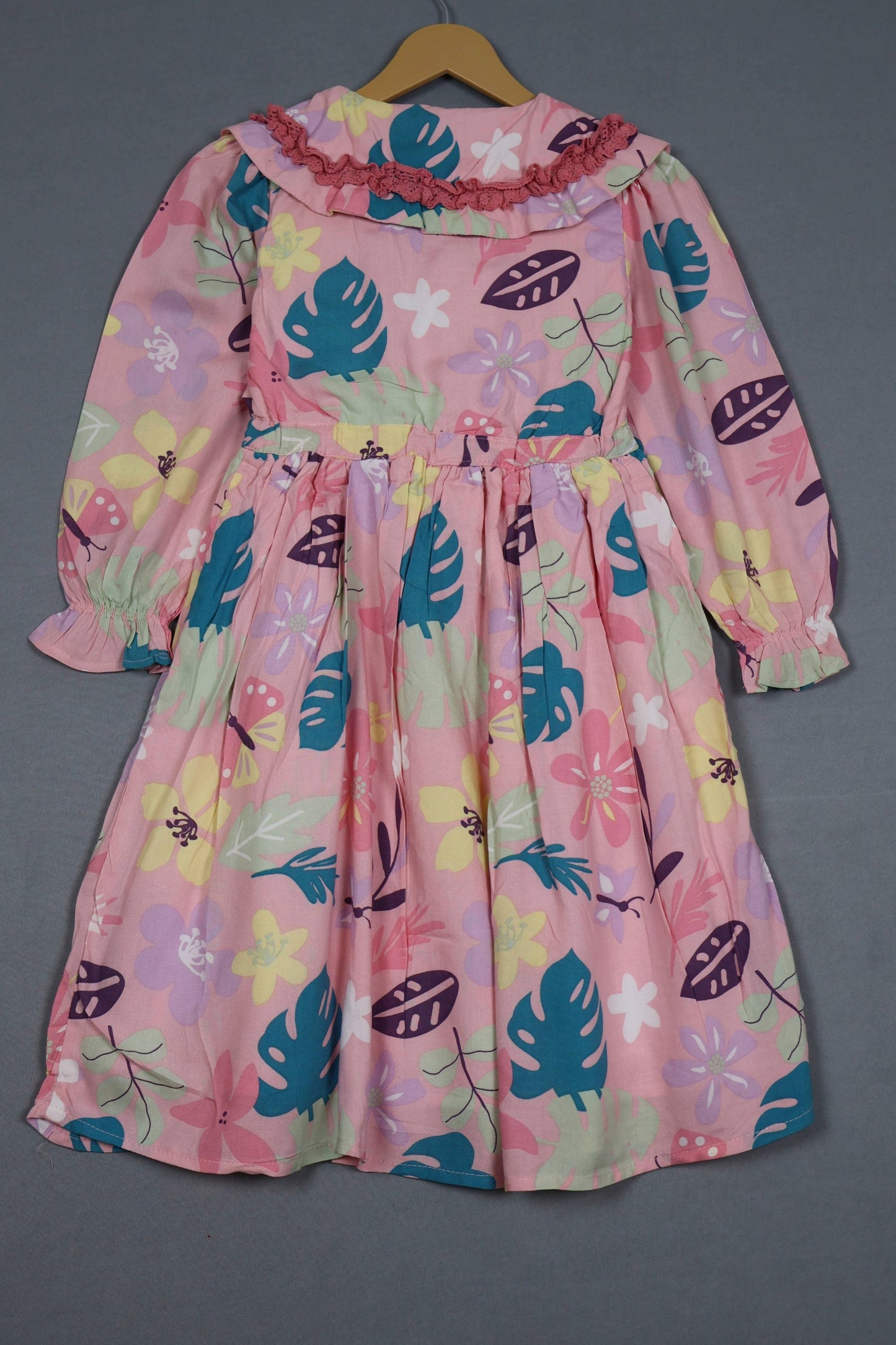 Blush pink cotton frock for girls with tropical floral print, long sleeves, and ruffle collar