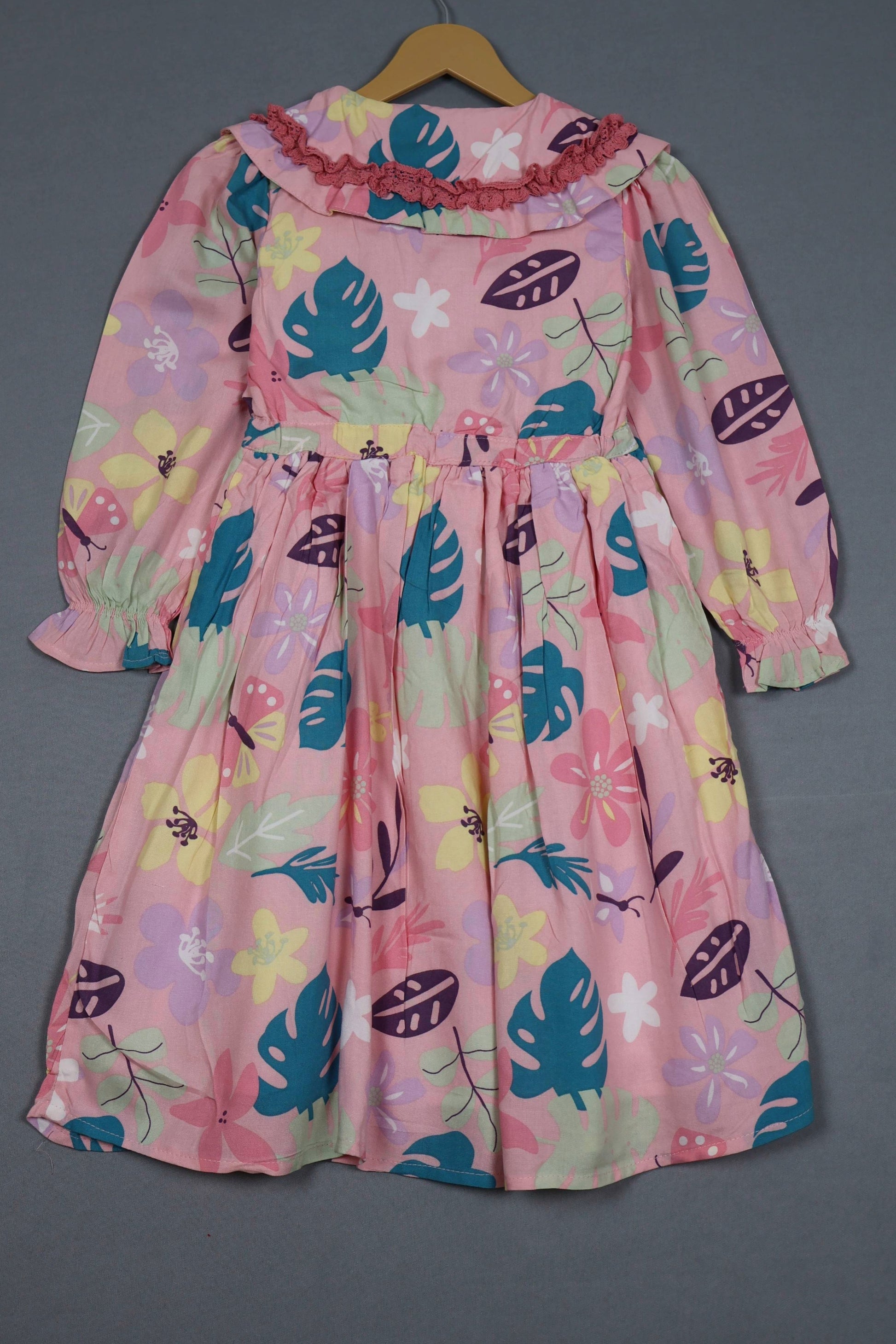 Blush pink cotton frock for girls with tropical floral print, long sleeves, and ruffle collar