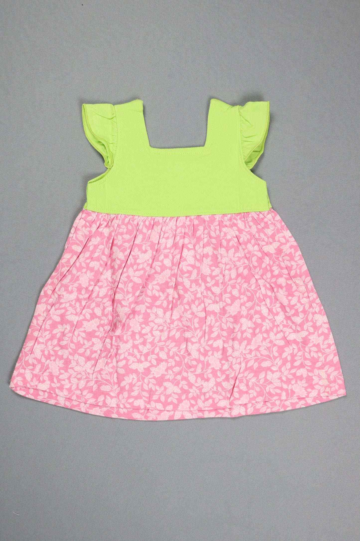Pink floral fabric and green fabric on a gray background