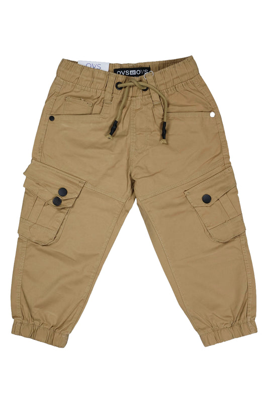 A pair of children's utility cargo pants in a classic beige color. The pants feature a comfortable elastic waistband with a matching drawstring, standard side pockets, and two large cargo pockets on the legs with secure black button closures. They are shown as a flat lay against a neutral background.